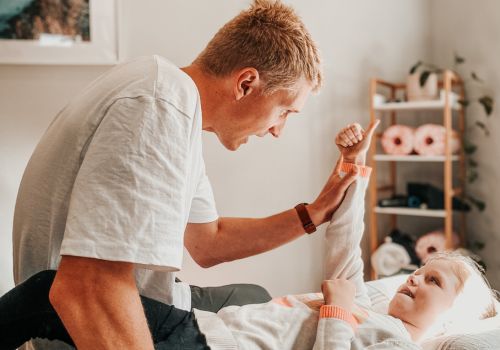 Dr Harry Brown adjusting a child